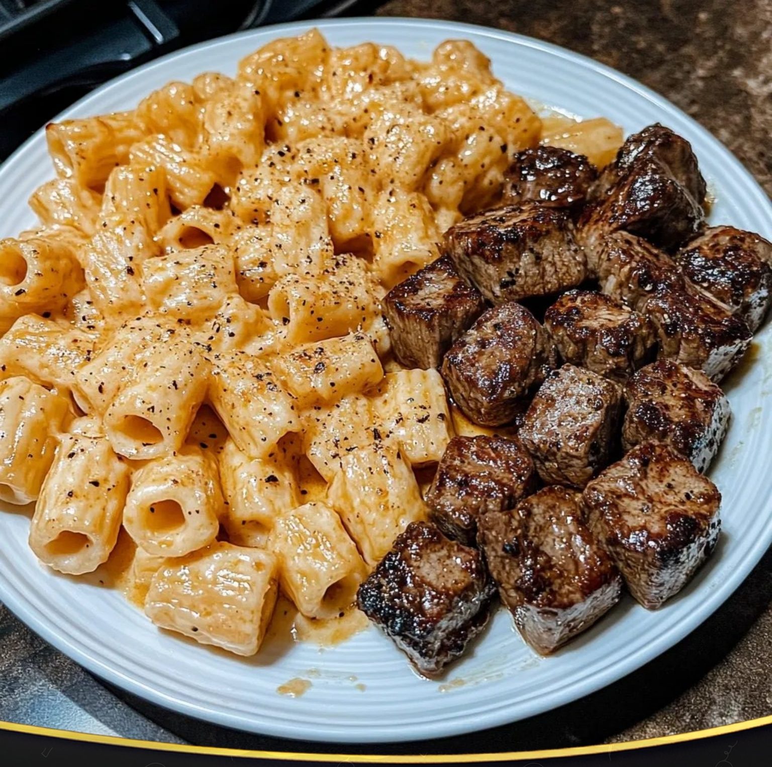CAJUN STEAK TIPS IN CHEESY RIGATONI PARMESAN SAUCE